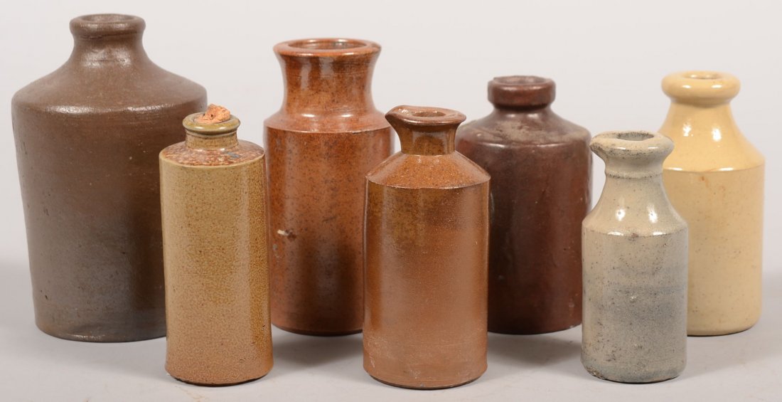 Seven Glazed Stoneware Ink Bottles. An assortment : Seven Glazed Stoneware Ink Bottles. An assortment including brown, white and gray glazes and tops, two with indented spouts. Heights: 5 5/8", 4", 4 1/2" and 4".