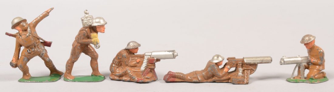 Five Painted Cast Metal Soldiers. A kneeling machi: Five Painted Cast Metal Soldiers. A kneeling machine gunner, a seated machine gunner, a prone machine gunner, grenade thrower and a soldier carrying a roll of barbed wire. 2 1/8"h. - 3"h. and 4 7/8"l.