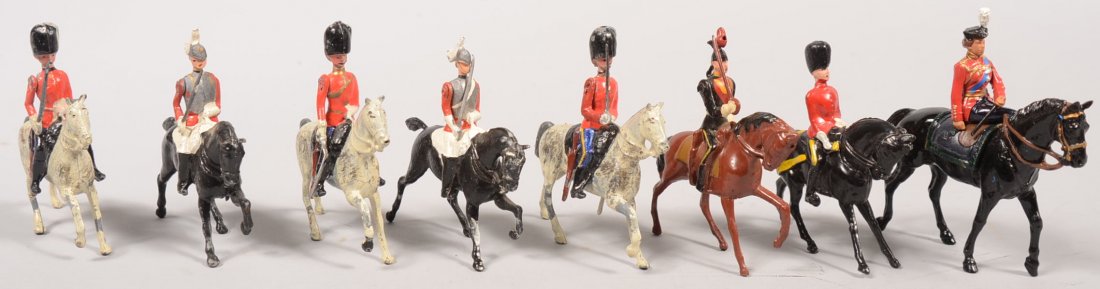 Eight Painted Cast Metal Mounted Horse Soldiers. F: Eight Painted Cast Metal Mounted Horse Soldiers. Four red tunic with bearskins. Two armor vested dragoons. Another in black on brown and a woman riding side saddle on a black steed and looking very mu
