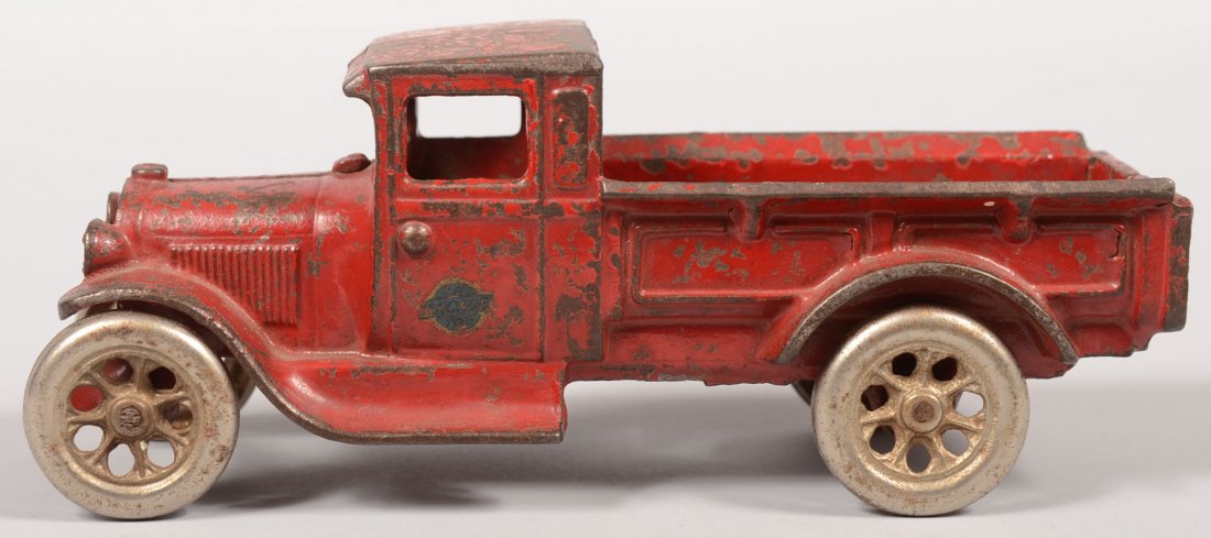 Arcade #210 Red Painted Cast Iron Truck. Open bed : Arcade #210 Red Painted Cast Iron Truck. Open bed truck has plated wheels and a platform in cab where a driver sat. Marks cast inside engine cover and decal on drivers door. 3 3/8"h. X 8 1/4"l. Note t