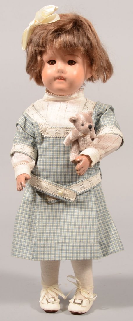 N.E. Schoenhut Painted Wood Girl Doll. Blue oval d: N.E. Schoenhut Painted Wood Girl Doll. Blue oval decal on back dated Jan. 17, 19__. Young lady has applied brown hair wig, pink lips, brown glass sleep eyes and movable joints in a blue belted play sm