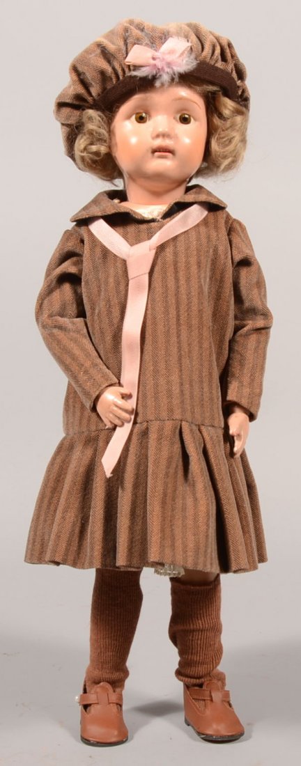 N.E. Schoenhut Painted Wood Girl Doll. Blue oval d: N.E. Schoenhut Painted Wood Girl Doll. Blue oval decal on back dated Jan. 17, 1911. Young lady has blonde hair wig, pink lips, painted brown eyes and movable joints in a herringbone velveteen jumper w
