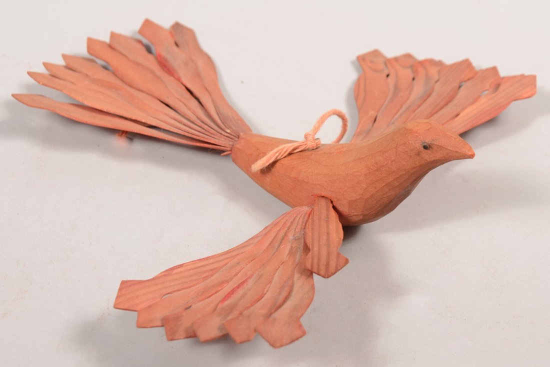 Folk Art Carved Red Colored Bird Whimsy. Carved on: Folk Art Carved Red Colored Bird Whimsy. Carved one piece body with pin head eyes and applied shape carved fan fold wings and tail. Attributed to the Bainbridge Artist of Lancaster County. 6 1/2"l. X 