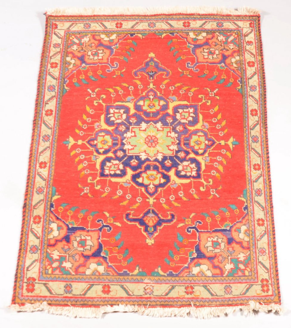 Oriental Wool Area Rug. Polychrome patterned rug h: Oriental Wool Area Rug. Polychrome patterned rug has red and blue barber pole edge binding and white cotton fringe. 55"l. X 40"w.