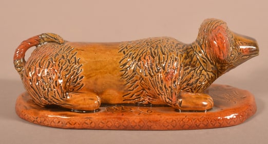Lg. Breininger 1976 Redware Reclining Dog Figure.
