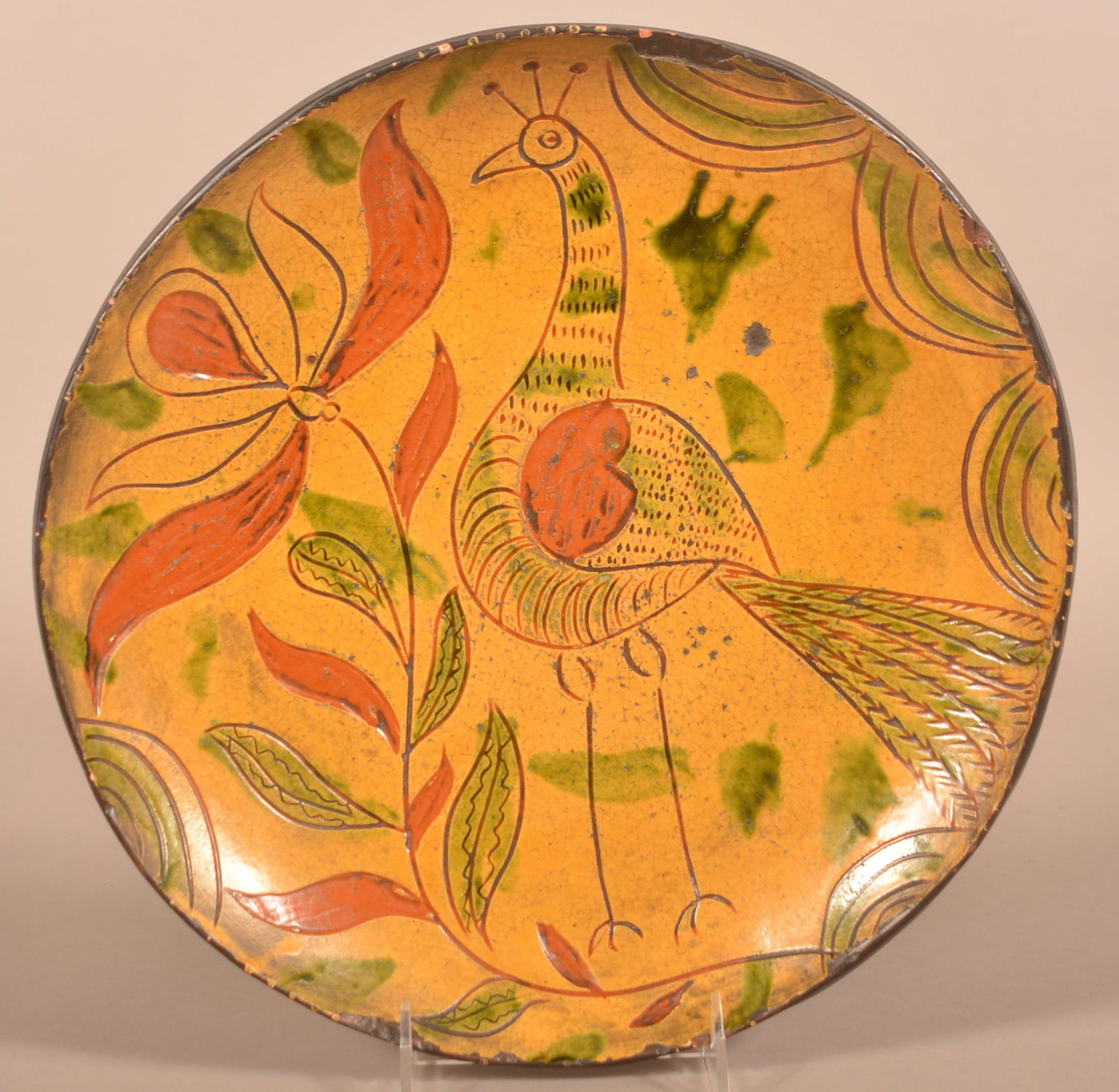 PA 19th C. Sgraffito Decorated Redware Charger.: Montgomery County, Pennsylvania 19th Century Sgraffito and Slip-Decorated Redware Charger. Decorated with incised peacock and flower, heightened with bittersweet, green and yellow slip. 12" diam.