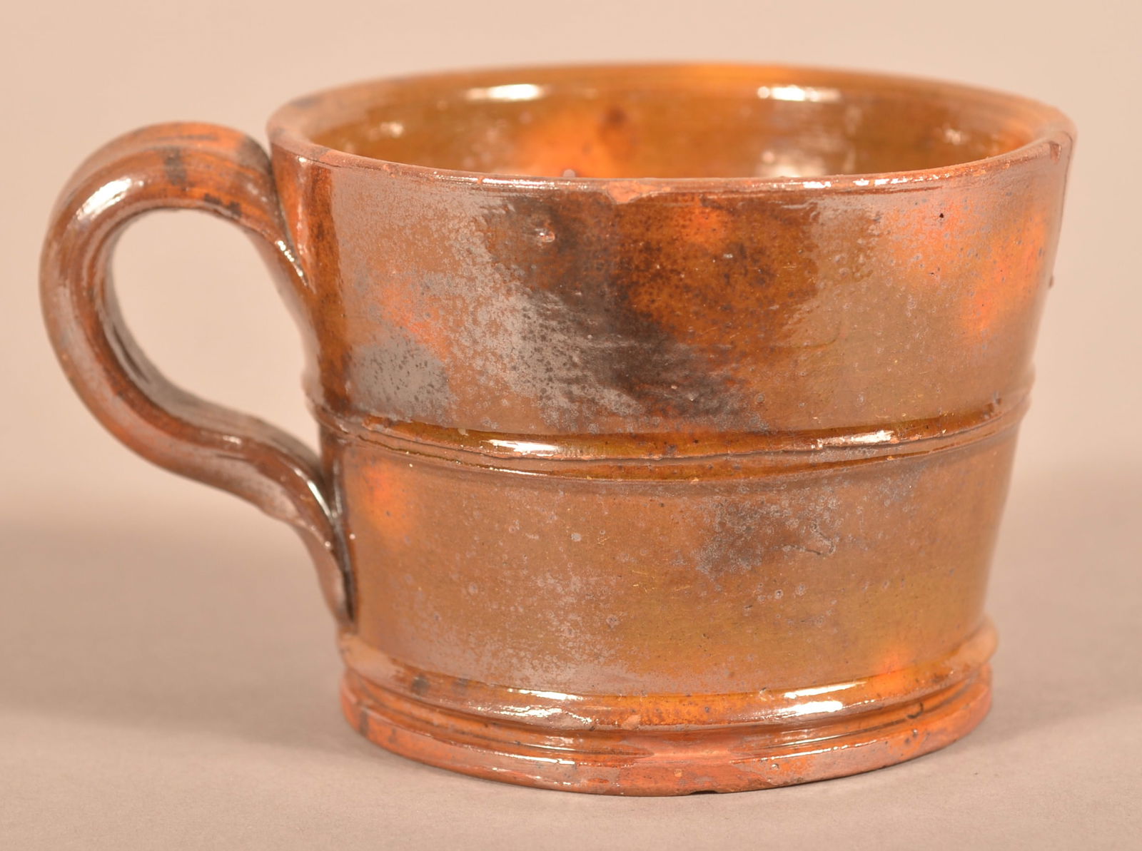 Antique Mottle-Glazed Redware Small Mug.: Antique Mottle-Glazed Redware Small Mug. Slightly tapered body with raised horizontal rib and applied loop handle. 2-3/4"h.