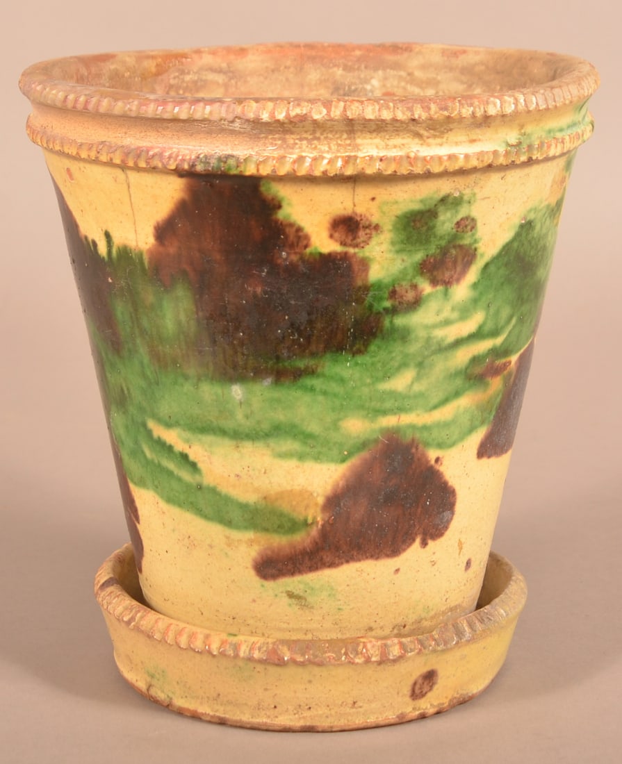Shenandoah Valley Glazed Redware Flower Pot.: Shenandoah Valley Polychrome Mottled-Glazed Redware Flower Pot. Attributed to J. Eberly & Co., Strasburg, VA, circa 1885-1899. Double coggle wheel rim, tapered body, attached saucer base with coggle w