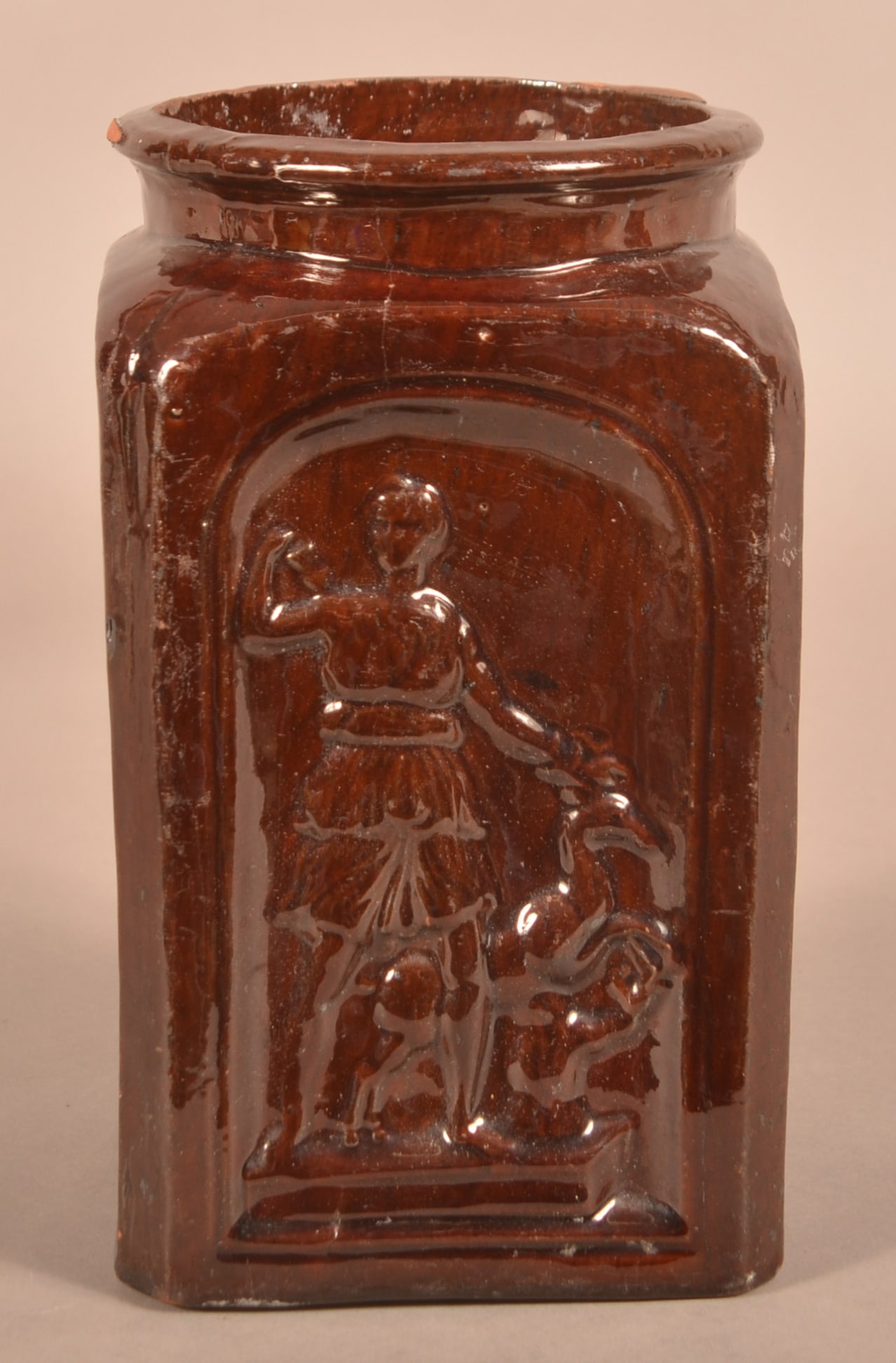 Gast Pottery 19th Century Molded Redware Jar.: Mid-19th Century Molded Redware Storage Jar. Attributed to Henry Gast Pottery, Lancaster, PA. Square base with embossed arched panels of hunter with stag and semi-round rim. Manganese glaze. 9"h.