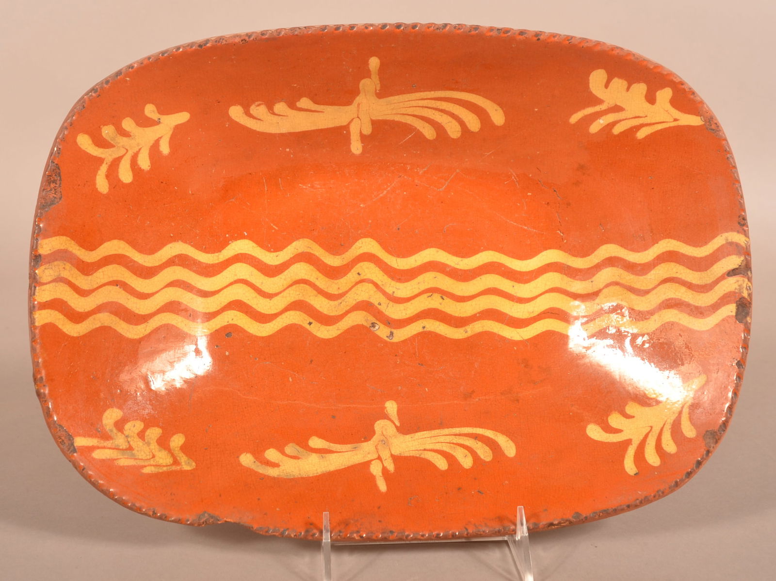 PA 19th C. Yellow Slip-Decorated Redware Loaf Dish.: Pennsylvania 19th Century Yellow Slip-Decorated Redware Loaf Dish. Rectangular form with coggle wheel edge. Central quadruple squiggle-line slip flanked by sprays and sprigs.14"w.