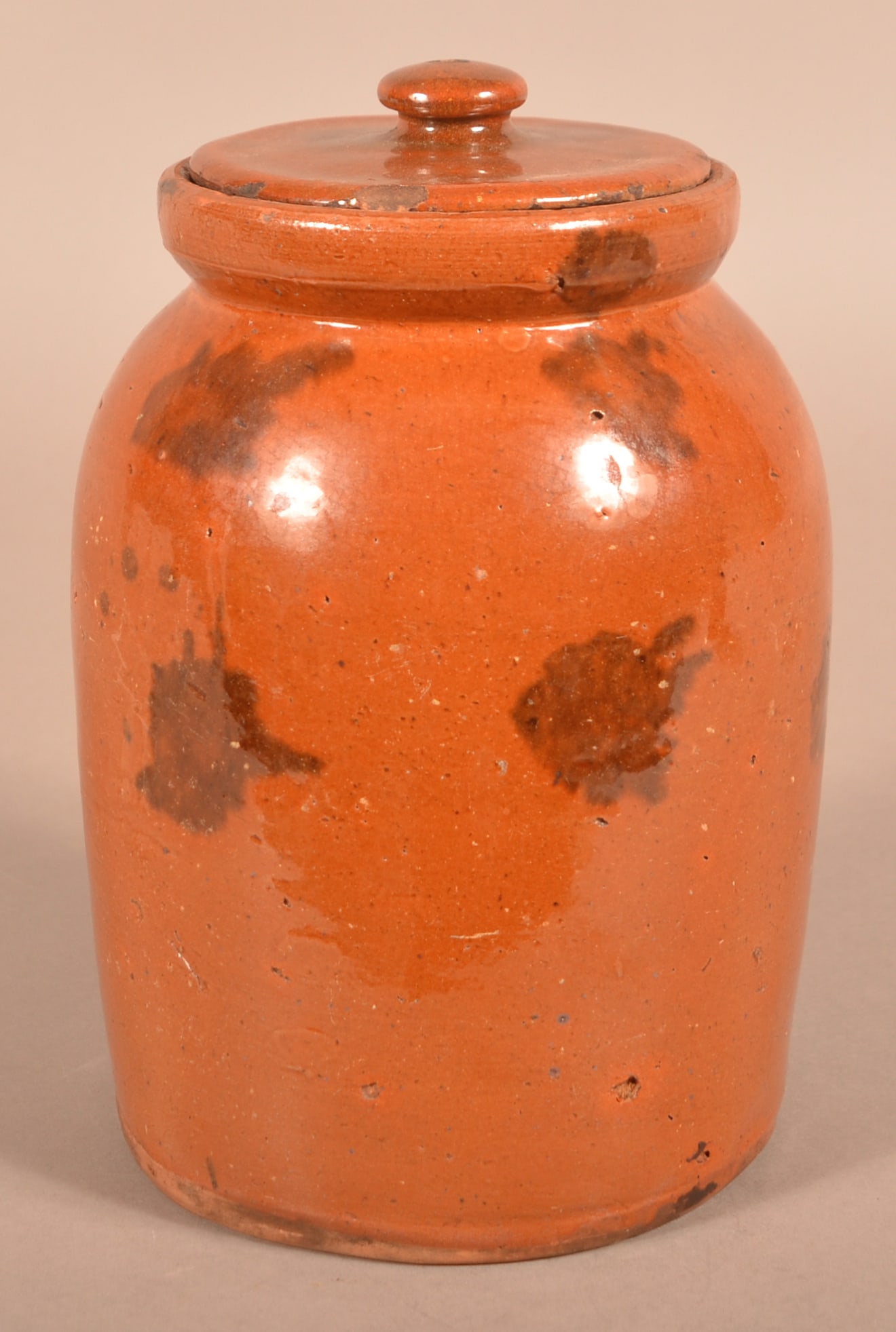 Antique Mottle-Glazed Redware Storage Jar.: Antique Mottle-Glazed Redware Storage Jar. Accompanied with a slightly oversized lid with a similar glaze. Jar measures 8-1/2"h.