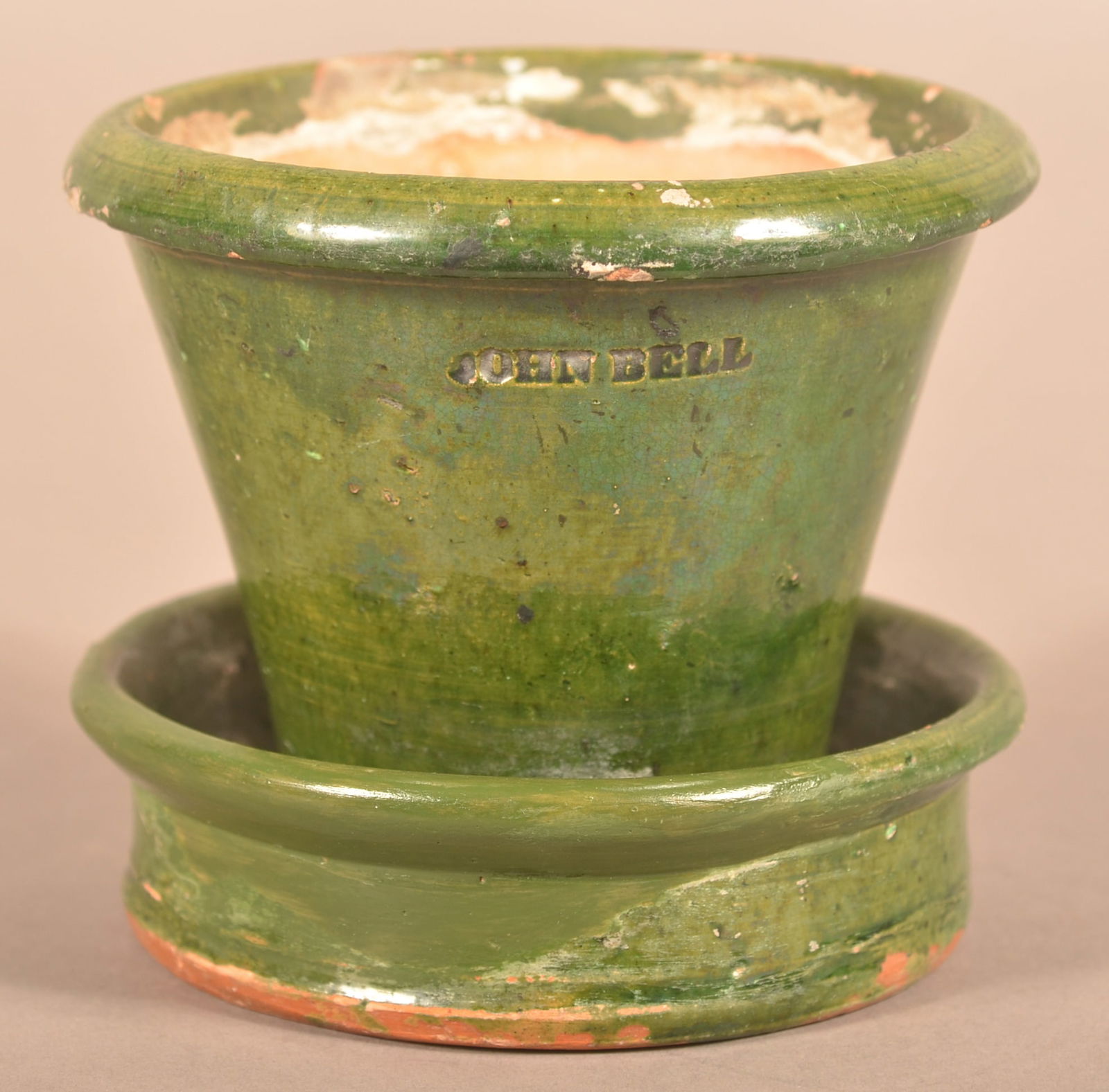 John Bell Spinach Green Redware Flower Pot.: John Bell Spinach Green Glazed Redware Flower Pot. Waynesboro, PA circa 1850-1880. Molded rim, tapered body and attached saucer base. 4-1/4"h.