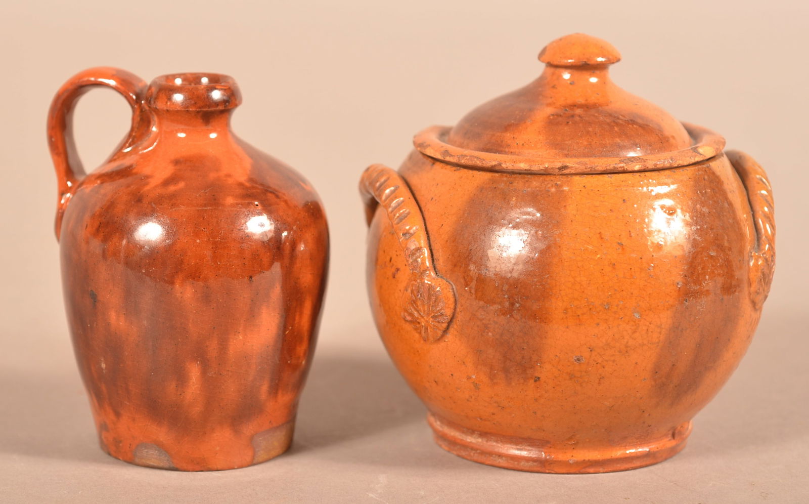 Two Miniature/Small Glazed Redware Vessels.: Two Miniature/Small Antique Glazed Redware Vessels. Miniature mottle-glazed jug, 3-1/4"h., and a small bulbous covered sugar bowl with applied stylized rope handles, 3-1/2"h.
