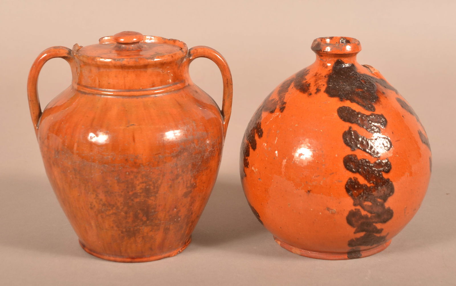 Two 19th Century Glazed Redware Vessels.: Two 19th Century Glazed Redware Vessels. Covered jar with open handles, 6-1/4"h. and an ovoid jug, 6-1/2"h.