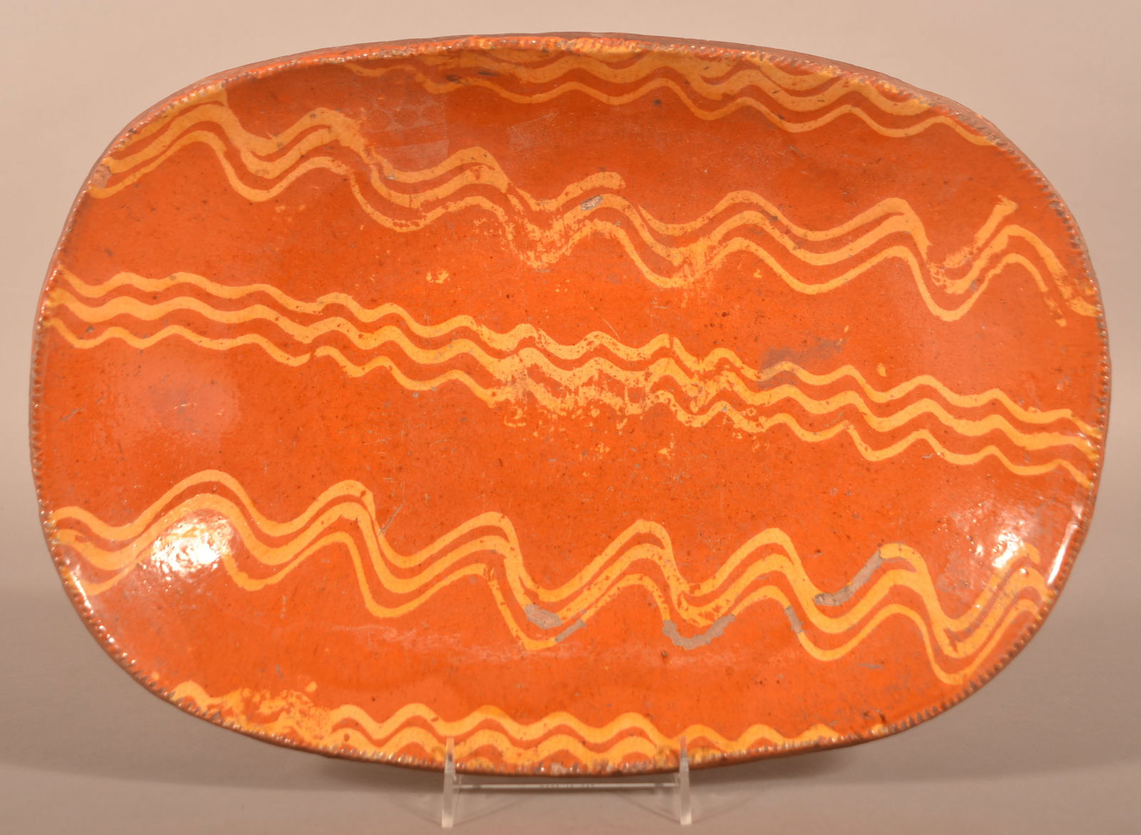 PA19th C. Yellow Slip-Decorated Redware Loaf Dish.: Pennsylvania 19th Century Yellow Slip-Decorated Redware Loaf Dish. Oblong form with coggle wheel edge. Squiggle-line slip decoration. 17-1/4"w.