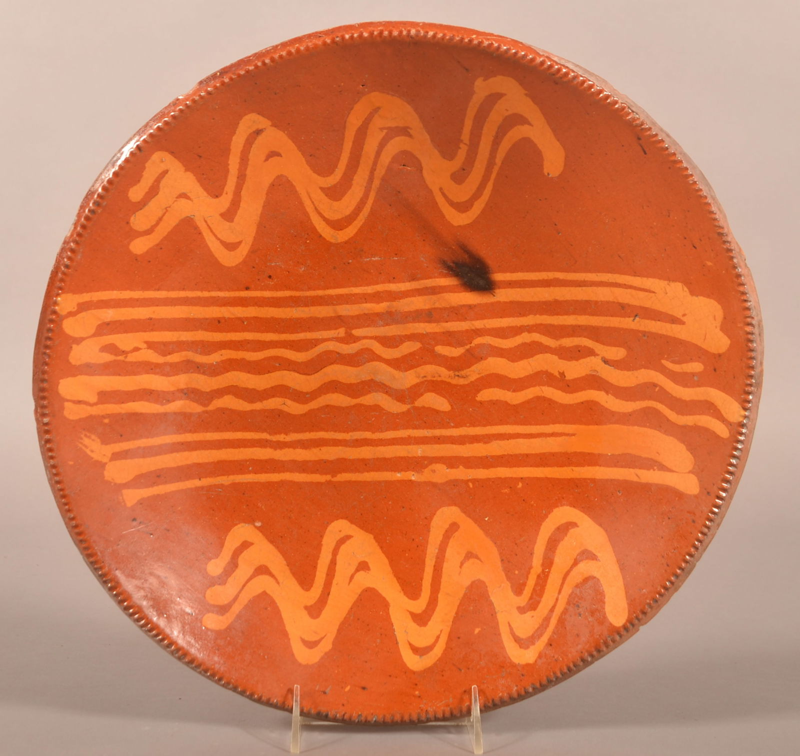 American 19th C. Redware Slip-Decorated Charger.: American 19th Century Redware Slip-Decorated Charger. Trailing slip bands and coggle wheel edge. Provenance: The late Jan Paden, Duncannon, PA. 14-3/4'' diam.