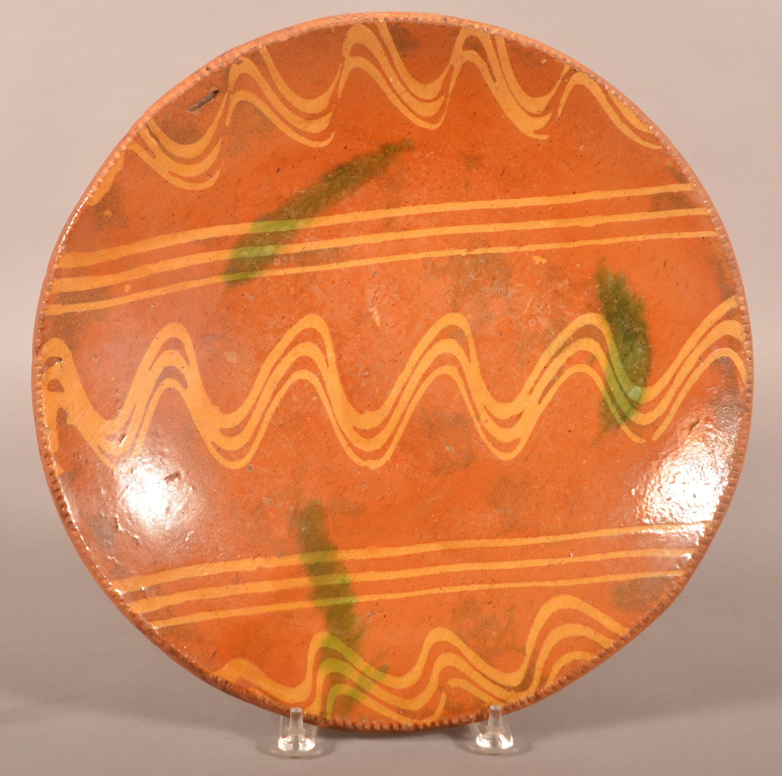 Large 19th Century Redware Slip-Decorated Charger.: Large 19th Century Redware Slip-Decorated Charger. Yellow slip with green splotch decoration. Provenance: The late Jan Paden, Duncannon, PA. 15-1/2'' diam.