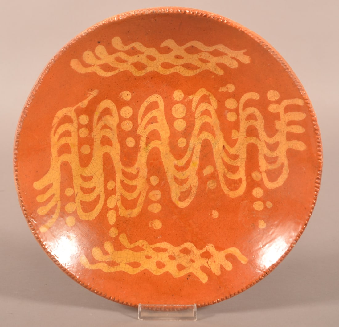 19th Century Redware Slip-Decorated Plate.: 19th Century Redware Slip-Decorated Plate. Coggle wheel edge with yellow slip decoration. Provenance: The late Jan Paden, Duncannon, PA. 10-1/2'' diam.