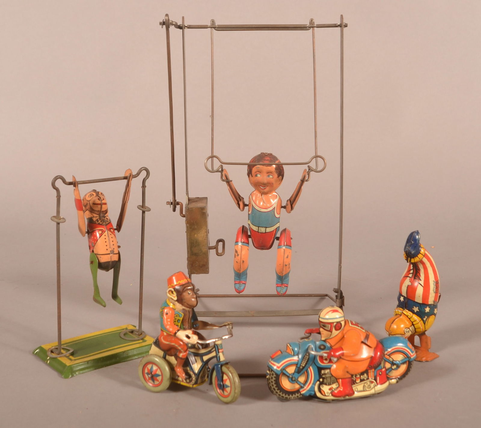 Five Vintage Tin Litho Wind-Up Toys.: Five Vintage Tin Litho Wind-Up Toys. Including acrobats, man on motorcycle and monkey on tricycle. Largest, 12"h.