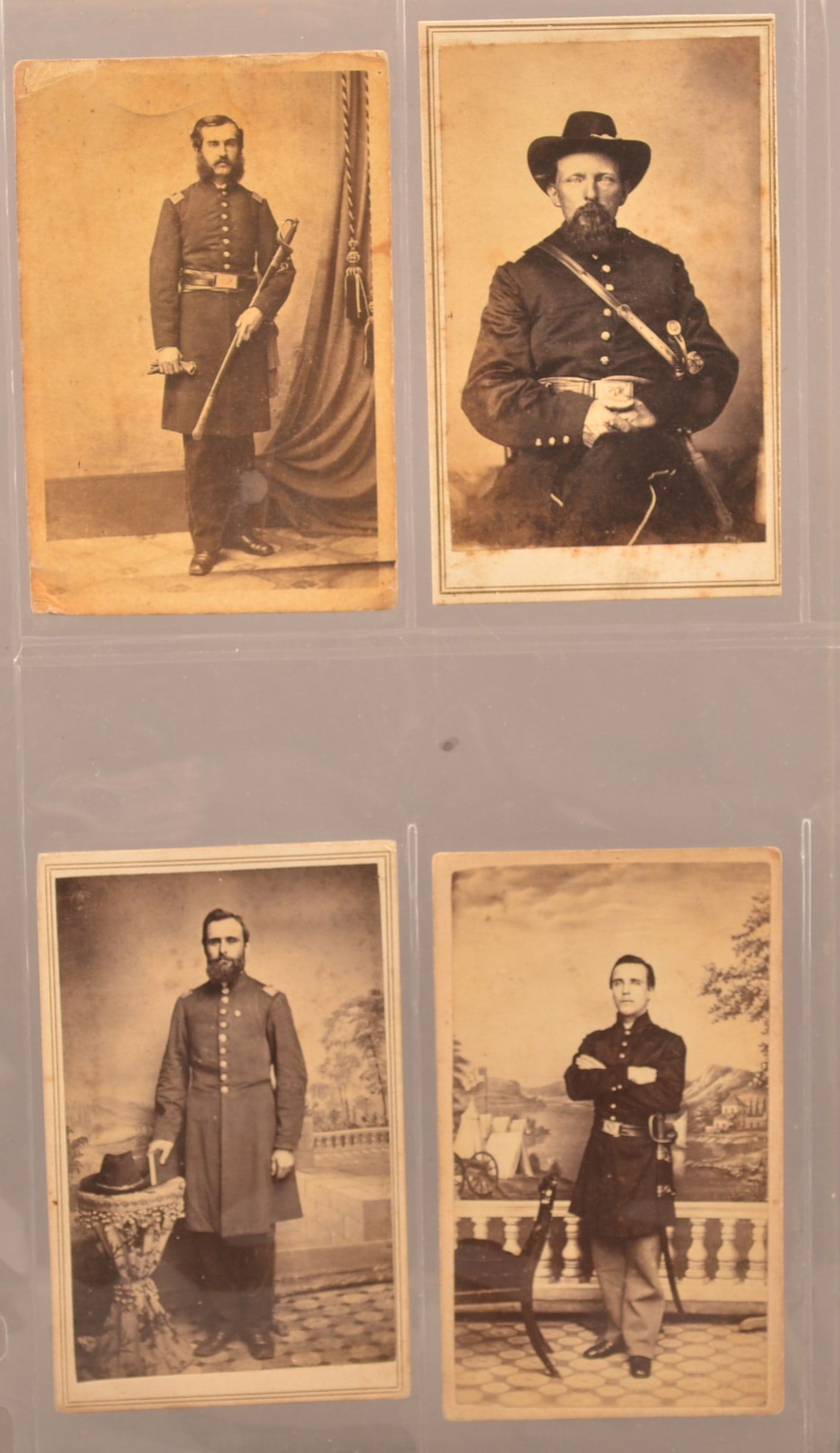 4 Union Company Grade Officer Civil War CDV's: Full standing view of officer cradling his sword. Backmark by J. B. Young Baltimore Street. Soiling and creasing. 3/4 seated view of officer with handle of sword visible. Collector's ID of Charles N B