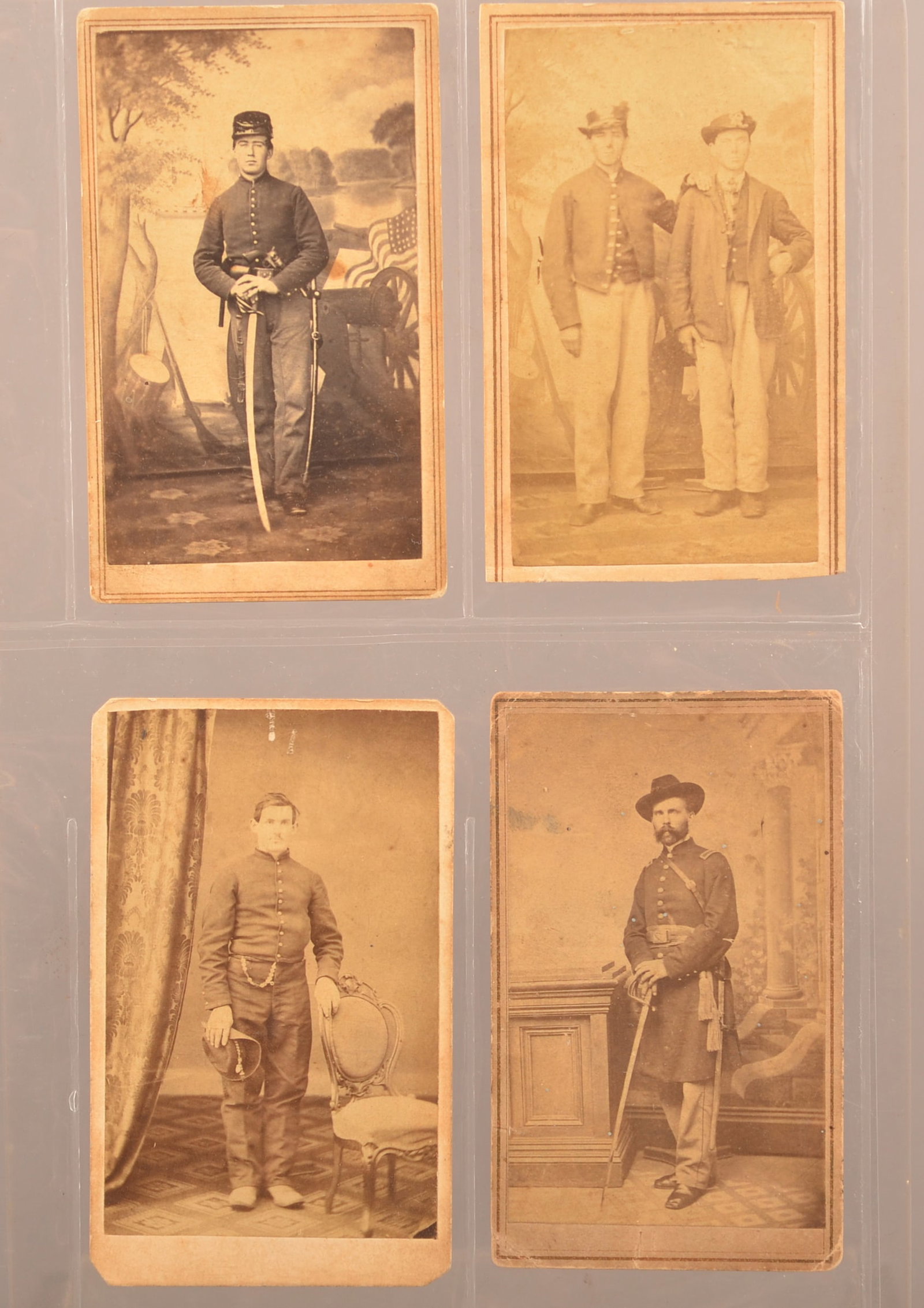 Group of Pennsylvania Backmark Civil War CDV's: Full standing view of an officer armed with his sword in front of a painted backdrop taken by Brownell, Scranton PA. Toning and staining. Full standing view of a private wearing a shell jacket holding