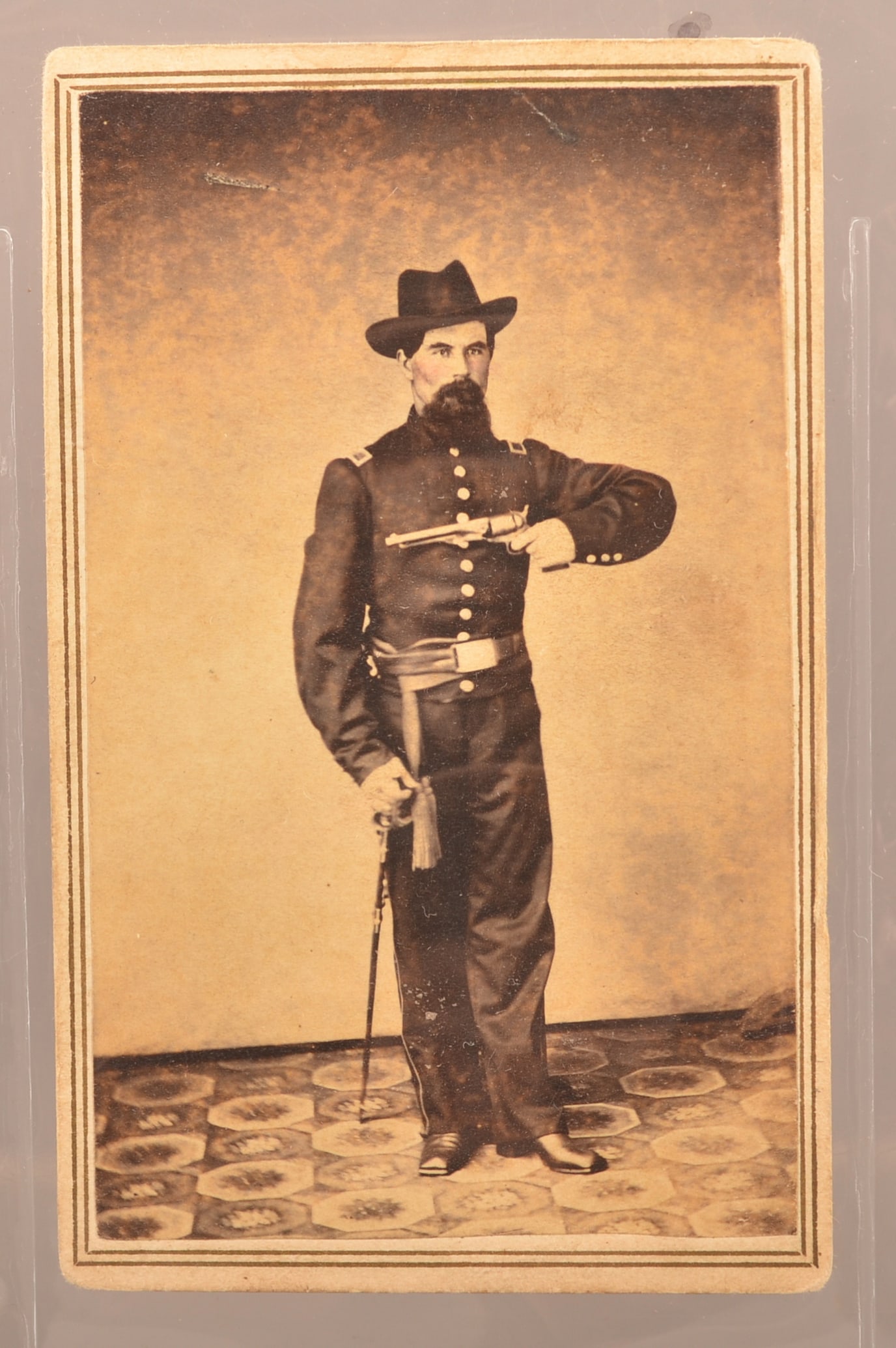 Great View of PA Officer Holding Colt Army Pistol: Full standing unidentified Union Army officer with a Lesher, Carlisle Pa backmark. Proudly displaying his Colt 1858 Army pistol with one hand and his other hand resting on his sword. Beautifully posed