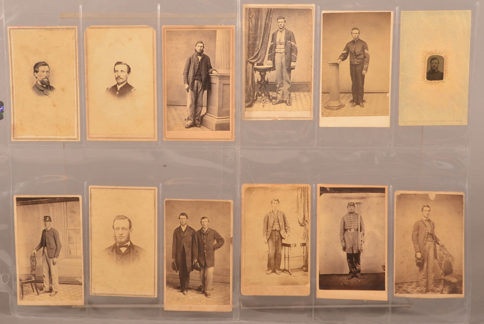 12 Civil War Images, Most with PA Backmarks: 1 gem size tintype and 11 CDV's with backmarks including New Oxford, Pittsburgh, Mechanicsburg, Williamsport, Scranton, Carlisle, York and Wellsboro. One nice copy shot of a musician holding his over 