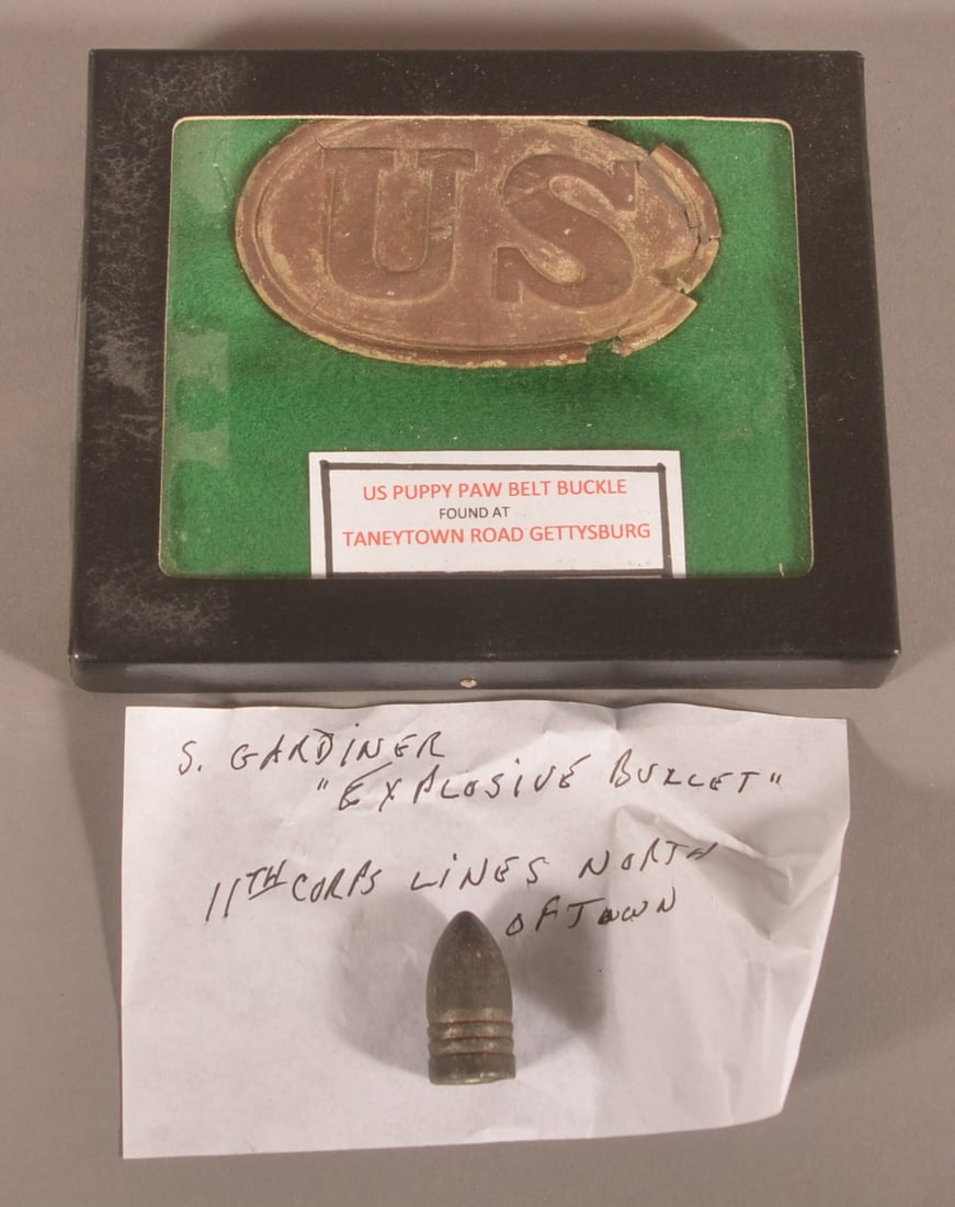 2 Gettysburg Civil War Relics: A Gardiner explosive bullet from the 11th Corps line and a U.S. puppy paw belt buckle noted as being found on the Taneytown Road.