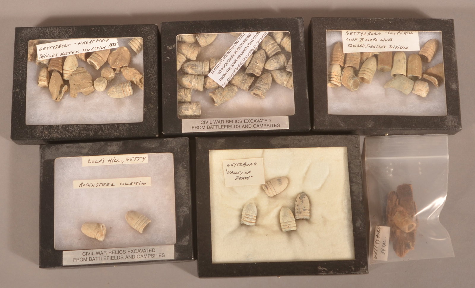 Rifle Rounds Recovered from Gettysburg Battlefield: 5 Riker cases and one loose round. The individual round is still in the wood it impacted and was later recovered. Collector's notes indicate some of these are from the Rosensteel collection, Shield's 