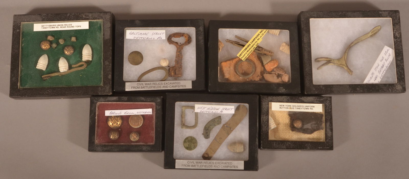 Nice Collection of Gettysburg Battlefield Relics: 7 Riker cases including nice buttons recovered from Barlow's Knoll and a Mississippi-Style Confederate spur recovered from Lee's retreat.