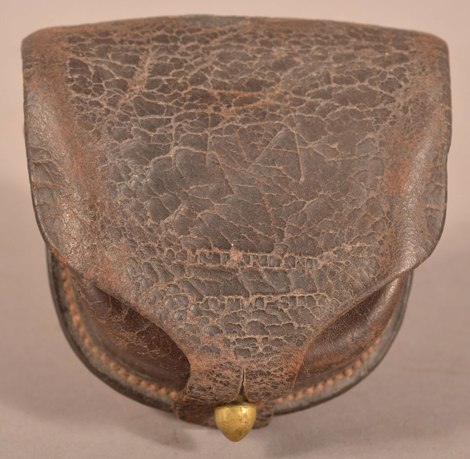 McFarland Percussion Cap Box: Excessive age cracks and crazing, dry aged leather finish, faint makers name on the outer flap, overall fair to poor condition.