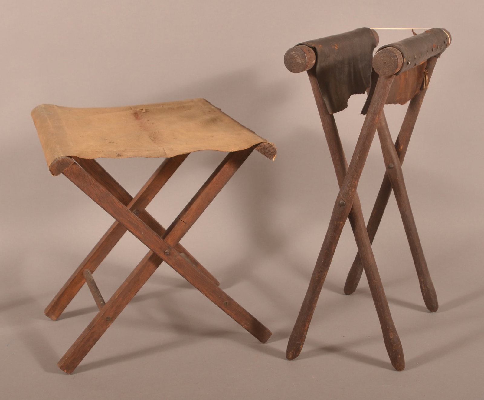 Lot of 2 Civil War Folding Camp Chairs: One with leather seat that is split and the other with canvas seat that is complete