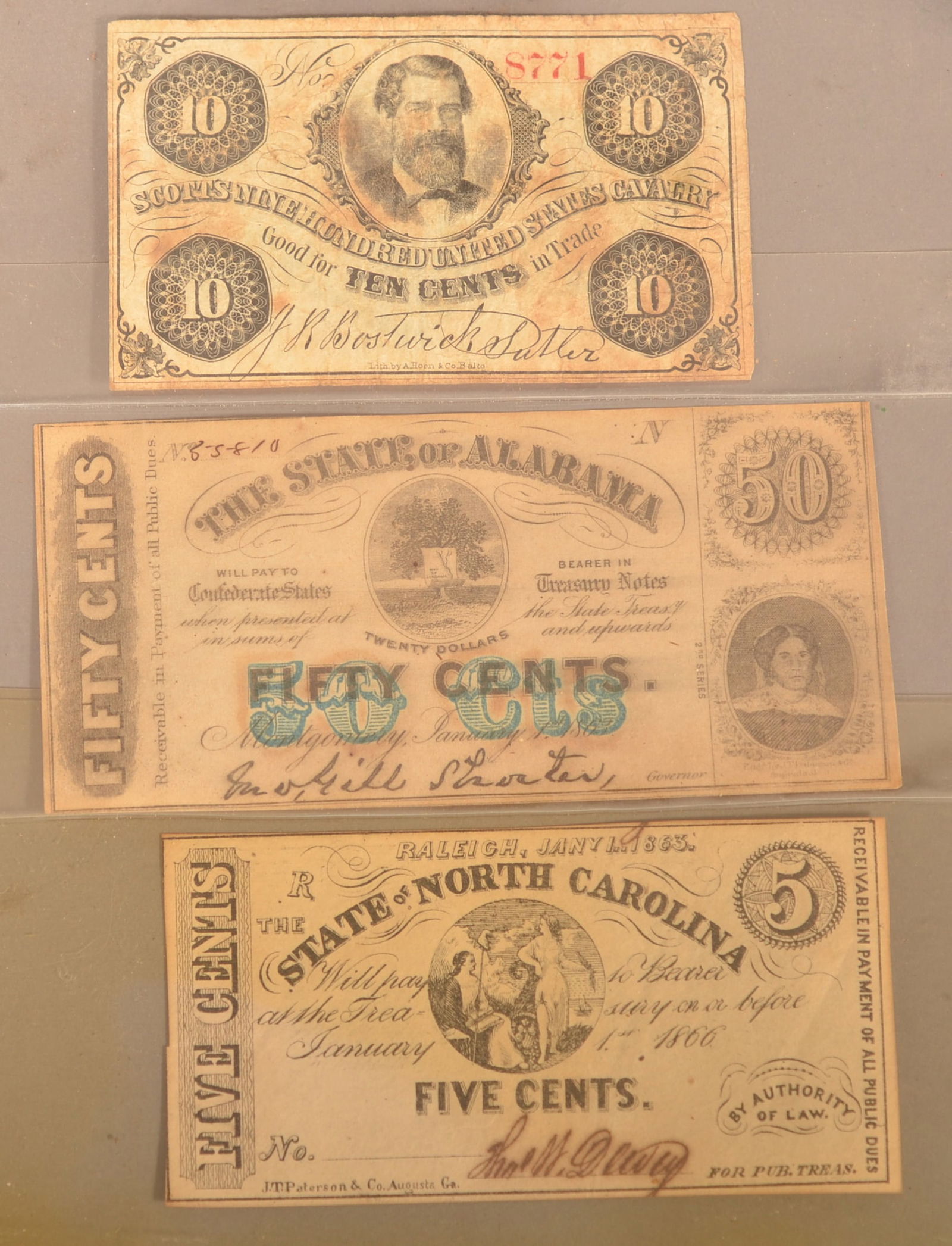 3 Banknotes: Includes a Scottish 900 United States Cavalry script note, an Alabama Confederate 50-cent note, and a North Carolina 5-cent note. Normal color toning signs of age and wear.