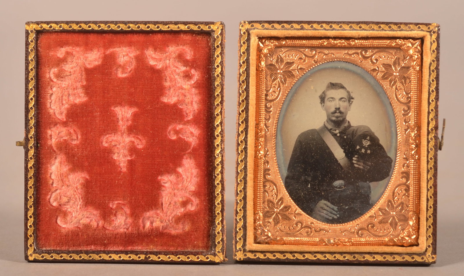 1/9th Cased Ambrotype of New Hampshire Volunteer: N.H.V. visible on the seated soldiers Kepi hat, dressed in full uniform with a pattern 1839 belt plate, missing case cover, expected wear and signs of age.