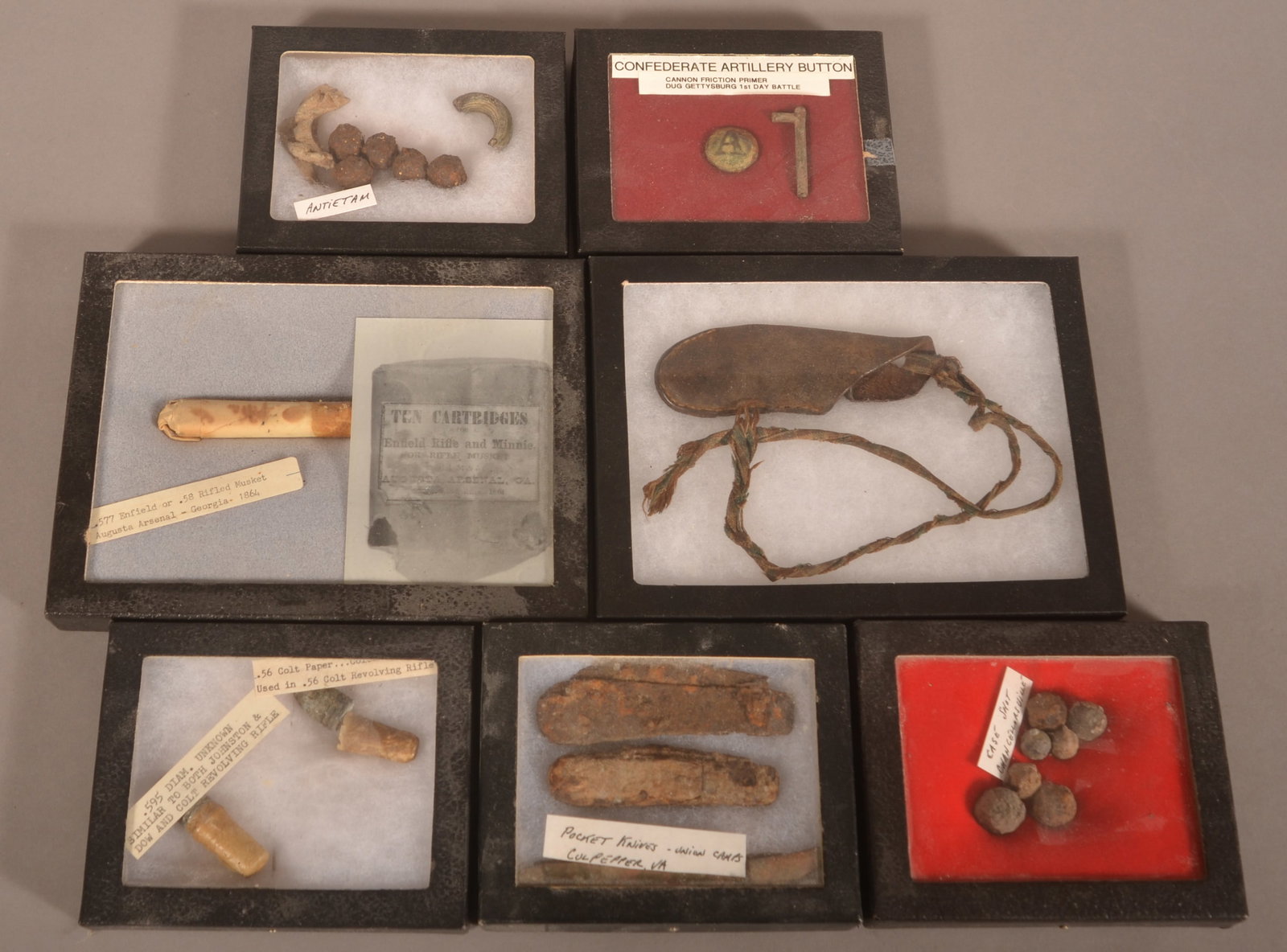 7 Riker Mounts of Dug Civil War Relics: Includes a Confederate artillery button, case shot and assorted relics. As-found relic condition.