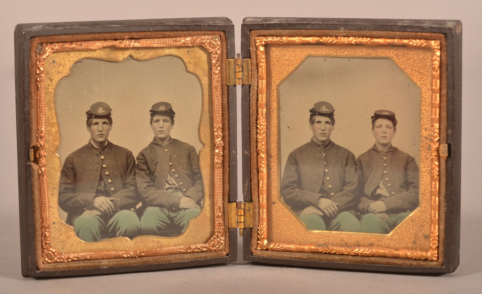 (2) 1/6th Cased Tintypes of 2 Union Soldiers: Is assumed to be of two brothers serving in the Union army, dressed in full uniform wearing Kepi hats in two different seated positions, clear image with expected wear and signs of age to the case, ov