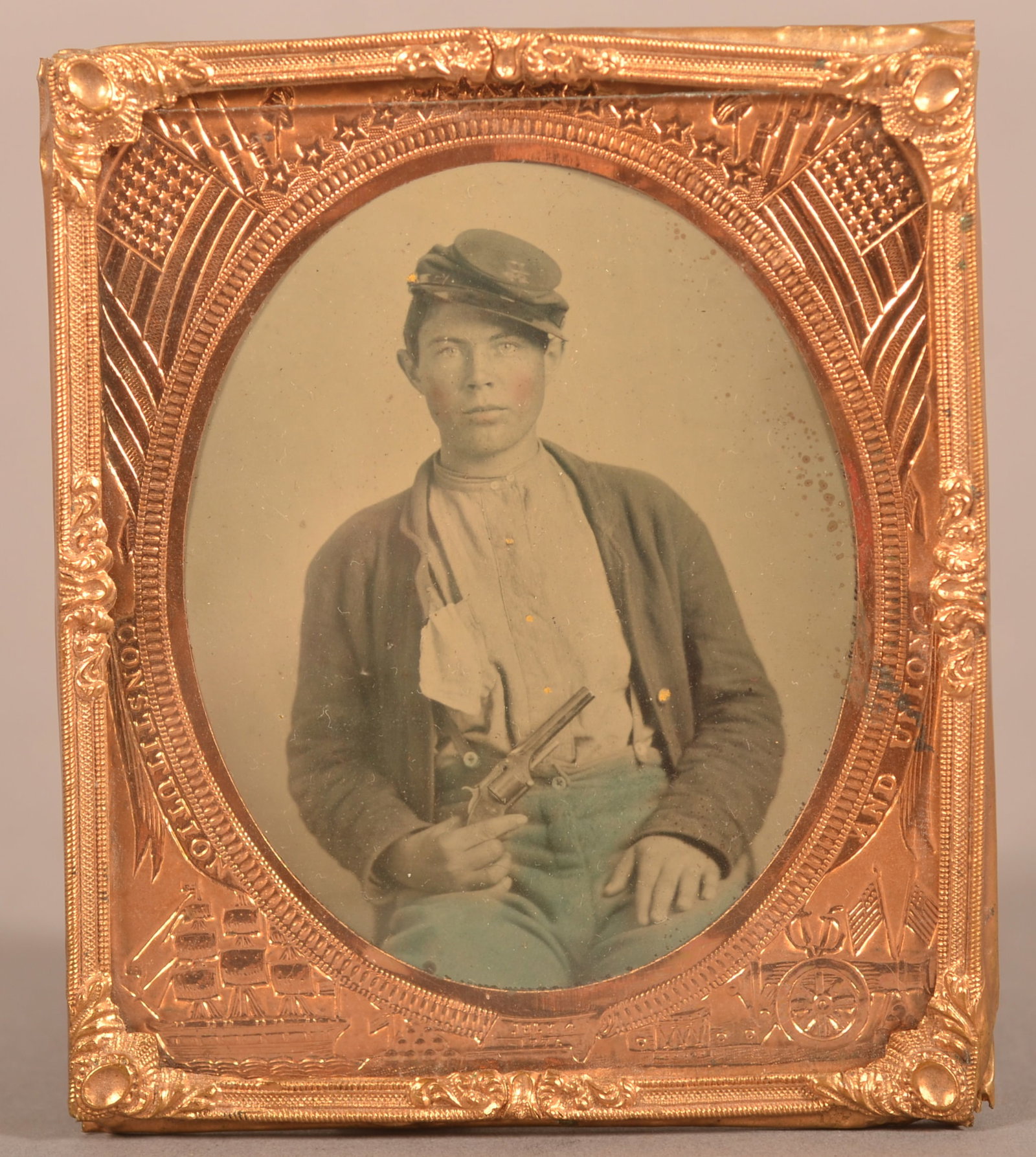 1/6th Plate Tintype of Union Soldier: Clear image of seated soldier in full uniform holding what appears to be a S&W 2nd model Army revolver, minor blistering and wear, overall good condition considering its age.