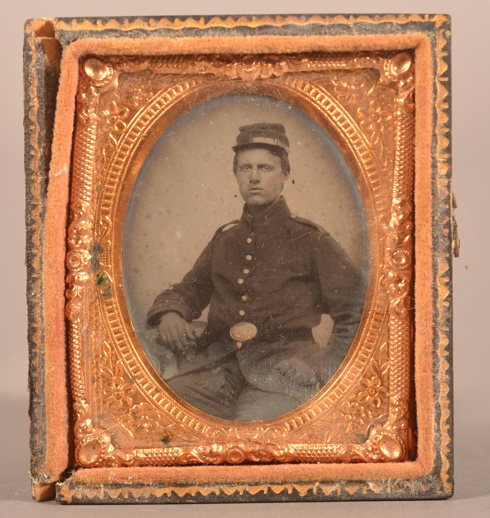 1/9th Cased Tintype of Seated Union Soldier: Dressed in full uniform wearing a pattern 1839 belt plate, minor image wear with a separated missing case lid, expected wear and signs of age, overall good condition.