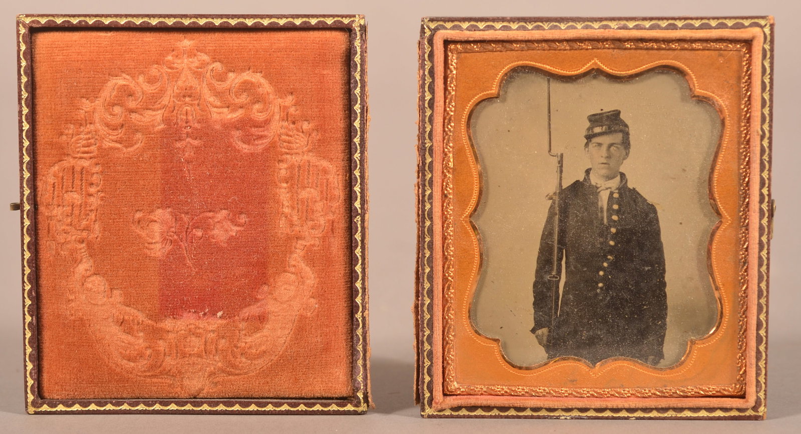 1/6th Cased Tintype of Union Soldier: Clear image of full-dressed uniform soldier holding a contract musket, unattached case lid, minor blistering with light speckled image loss, overall fair to good condition.
