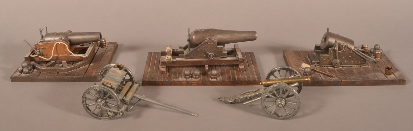 Grouping of Model Artillery Cannons: Metal and composition construction, largest has a 6" barrel, some stands have unattached cannonballs, overall good condition.