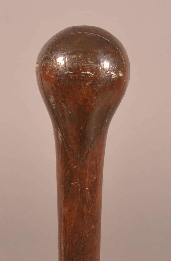 Civil War Era Drum Major's Baton: Turned, wood construction with a brass-wrapped tip, large age crack appearing on the handle, loose fitting brass attachment, expected finish and age wear. Measures 45-1/2" long.