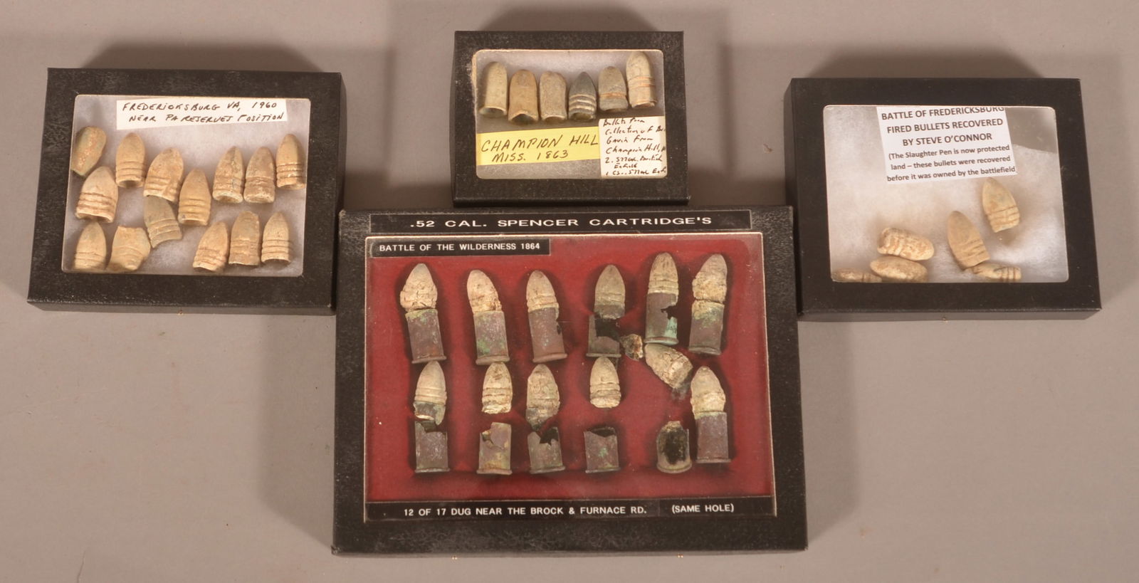 Recovered Minie Balls and Spencer Cartridges: 4 Riker mounts. As-found dug, relic condition.