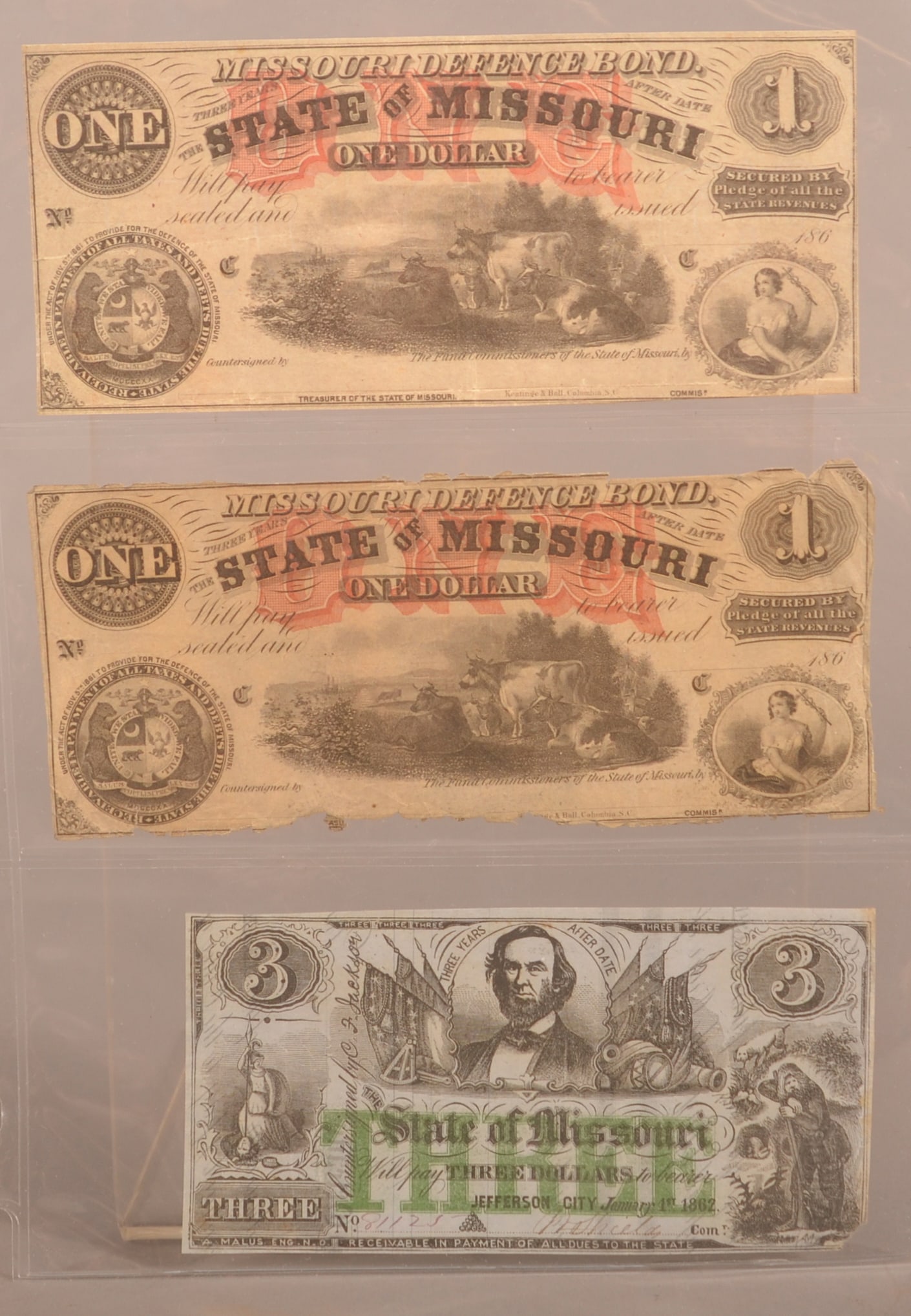 3 Missouri Defense Bonds: Includes two unissued $1 bonds featuring a rural scene with bell at the bottom, also included is a $3 note dated 1862, showing crease and folds with one having significant loss around the border, over