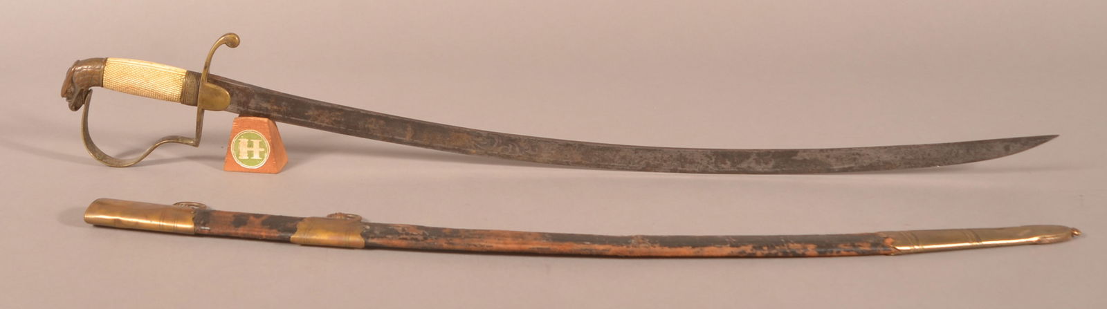 War of 1812 Light Artillery Officer's Sword: 29" engraved blade showing cannon barrels and floral designs, engraved illegible maker's mark on the ricasso due to excessive pitting and oxidation, brass eagle head pommel with brass hilt, carved bon