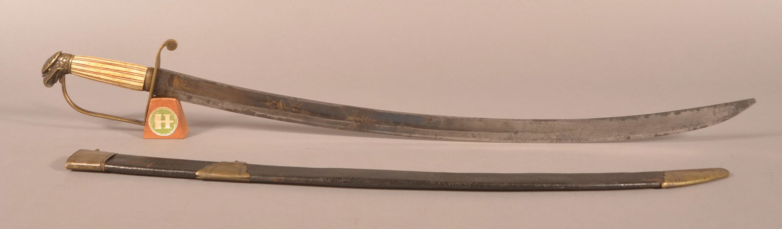 War of 1812 Mounted Infantry Officer's Sword: 28" engraved blade with a chipped point, floral and archery engravings with flag and drums, brass eagle head pommel with a simple D-guard, bone carved handle, dark oxidation spots and areas of pitting