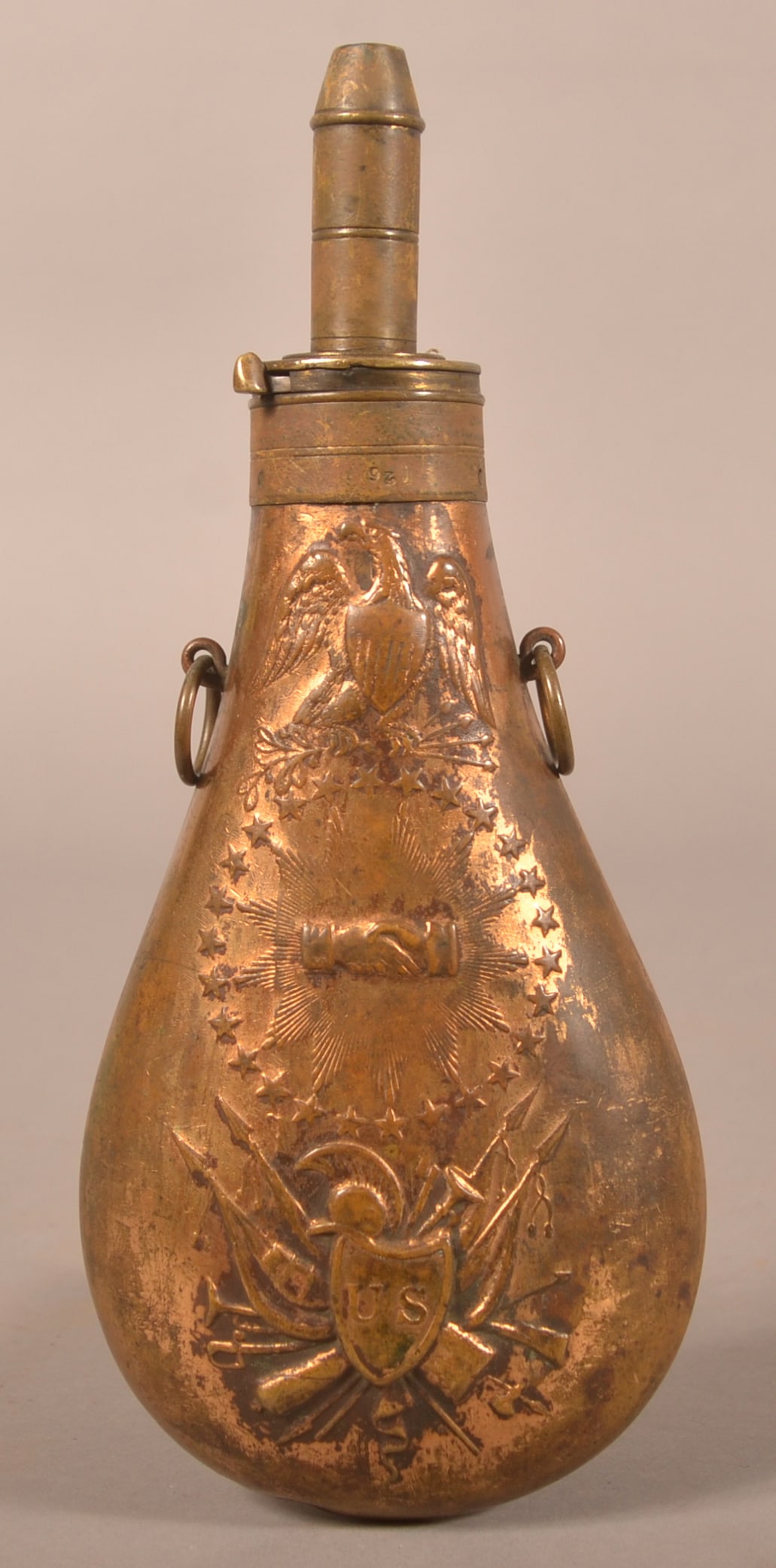 1832 Dated R. Dingee Batty "Peace" Powder Flask: Embossed with oval stars and eagle and shield motif above clasped hands, faded worn finish with no original varnish present, has both circular suspension rings.