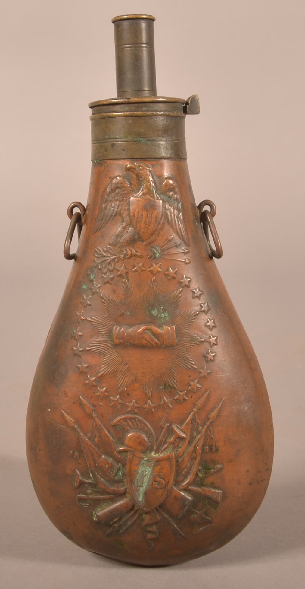 1837 N.P. Ames "Peace" Powder Flask: Embossed with oval stars and eagle and shield motif above clasped hands, crisp raised embossing, areas of tarnish and signs of age, traces of original varnish are still present, has both circular susp