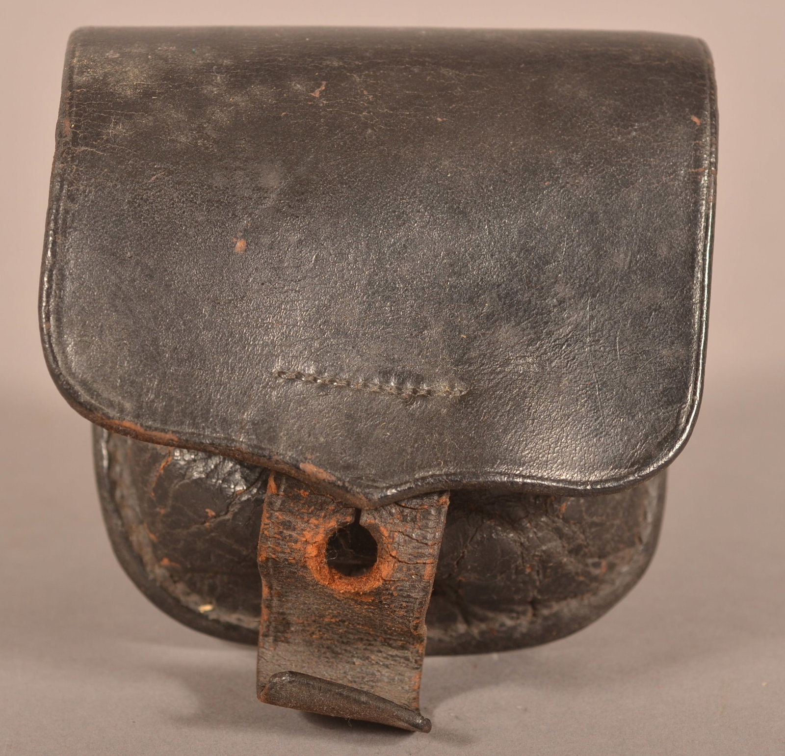 US Boston Naval Percussion Cap Box: Clear markings on the interior, excessive crazing, intact stitching with two belt loops, dry aged leather finish that is still pliable, overall fair condition.