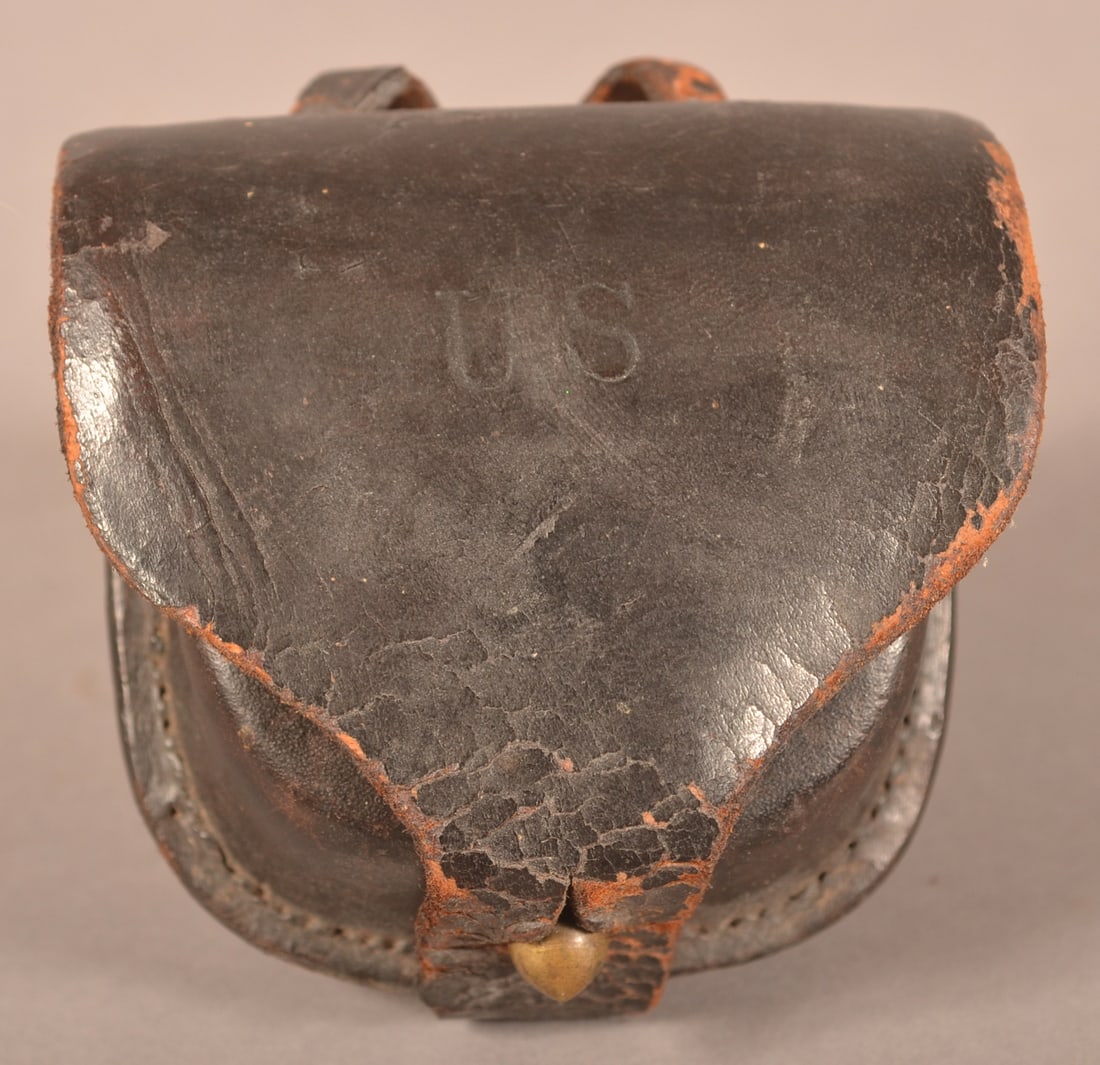Jewell Pattern 1850 Percussion Cap Box: Clear maker's marks on the inner flap, no original wool is present, dry, age-cracked leather with finish flaking and crazing, leather is aged but still pliable, intact stitching with belt loops intact