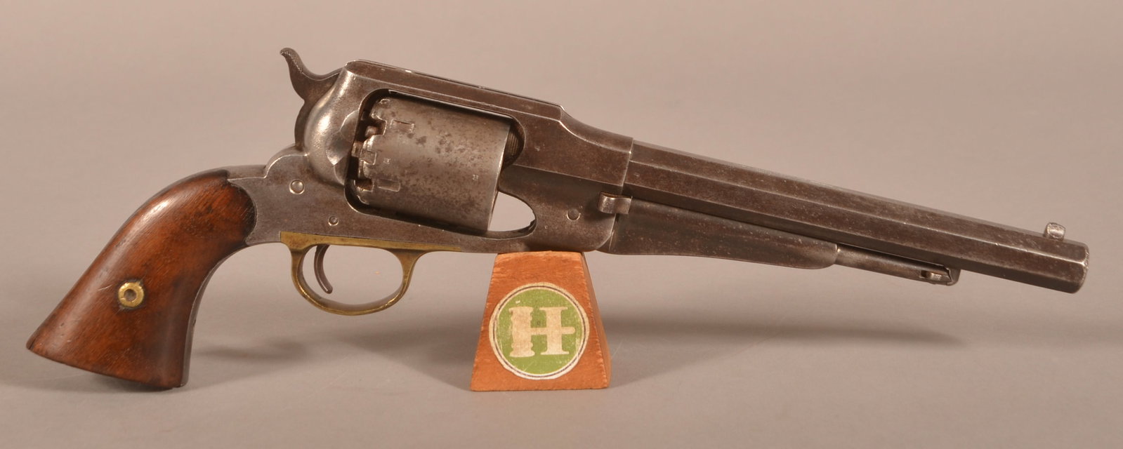 Remington New Model 1858 .44 cal. Perc. Revolver: SN 87982, Brass trigger guard with 2-piece walnut grips, faint and worn three line markings on the top barrel flat, various sub inspectors marks, correct-working action, excessively worn and faded fin